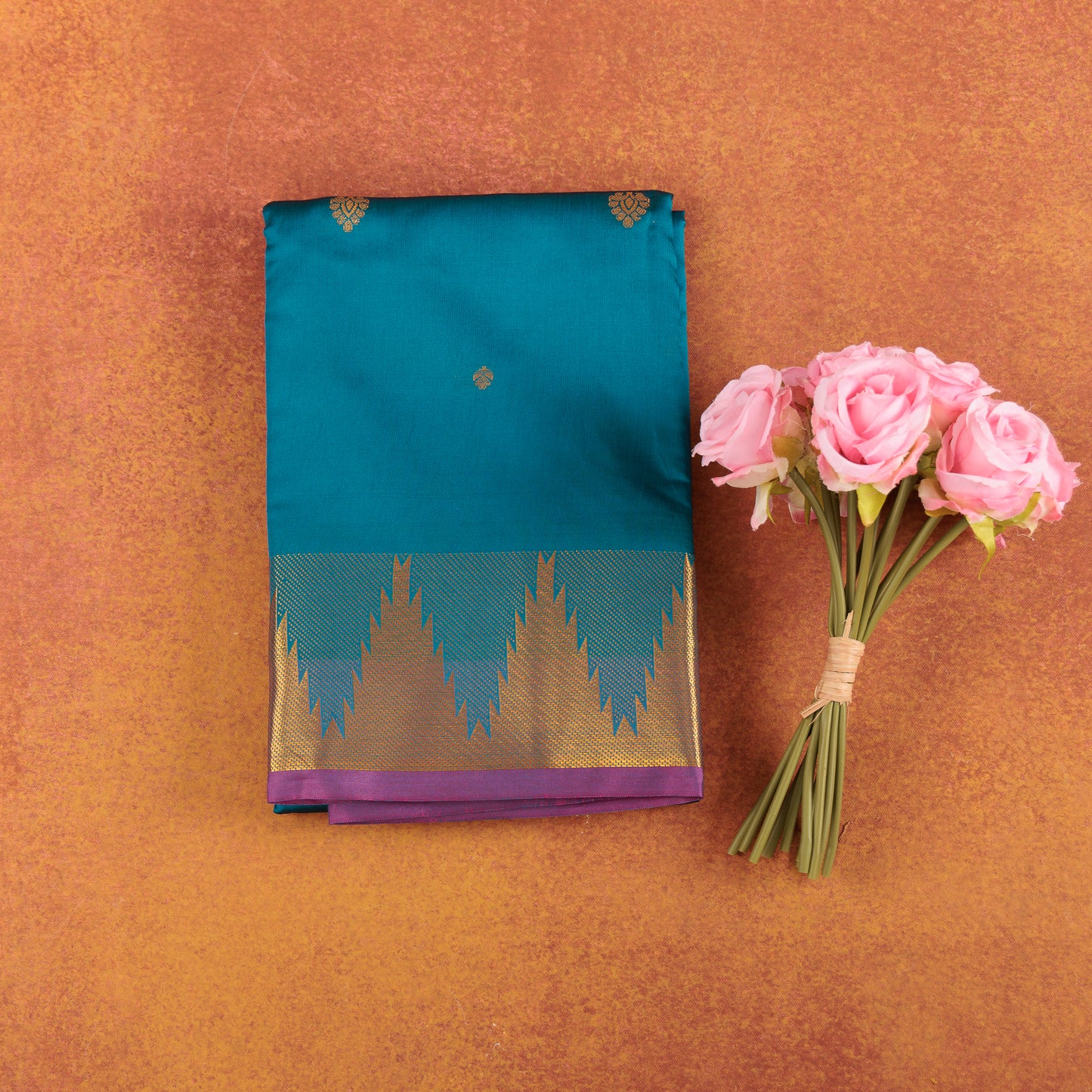 Teal-blue-kanjivaram-semi-silk-saree-with-pink-contrast-temple-zari-border.