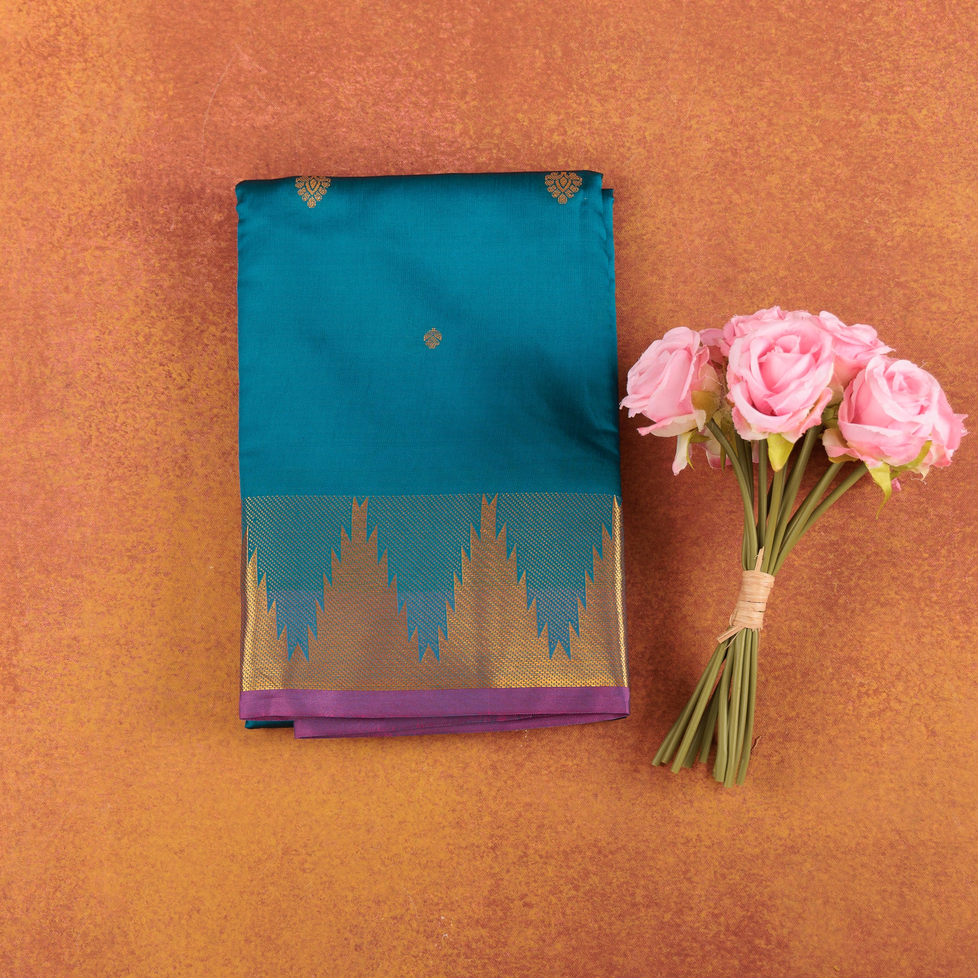 Teal-blue-kanjivaram-semi-silk-saree-with-pink-contrast-temple-zari-border.