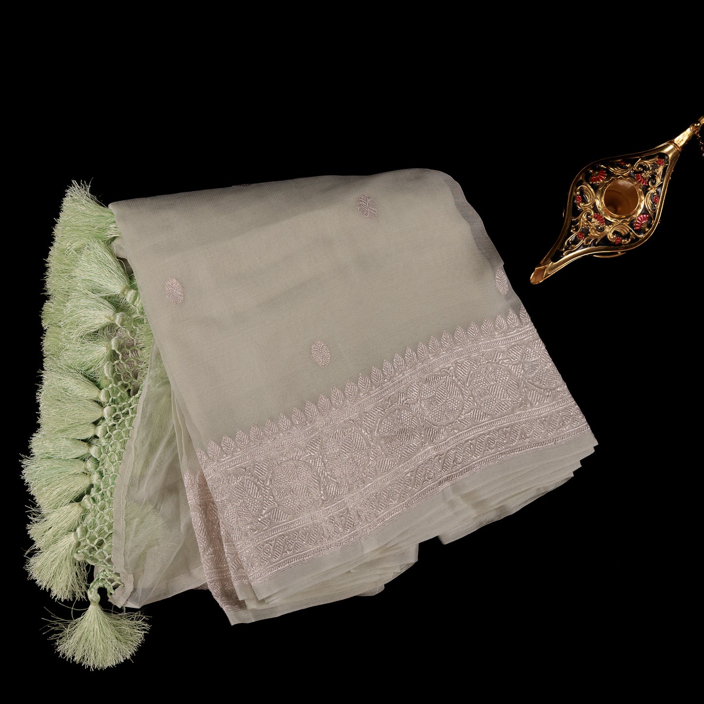Sage green pastel Banarasi chiffon saree with silver zari border and tassels for women