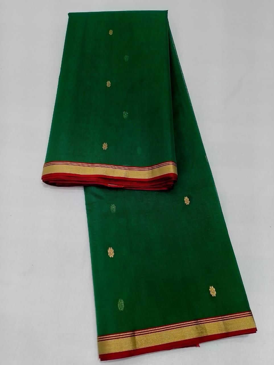 Bottle green cotton Kota Doria saree with gold buti motifs and contrast border, neatly folded and displayed.