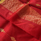 “Classic red Chanderi cotton silk saree with gold buti motifs and gold zari border, neatly draped and displayed.”
